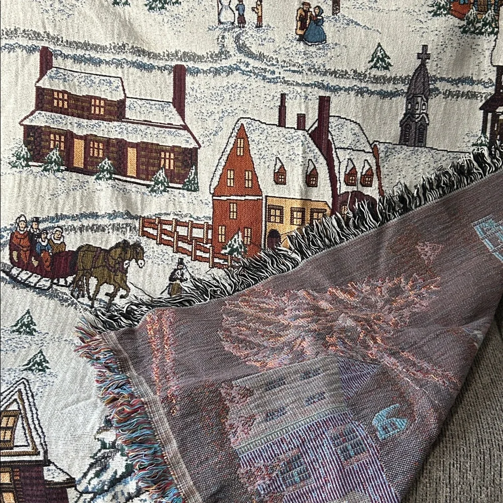 woven tapestry throw blanket featuring a winter village scene fringe edges
